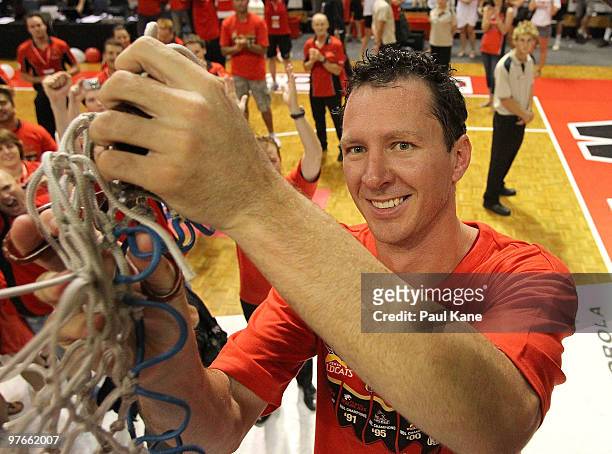 Martin Cattalini of the Wildcats cuts the net from the ring after defeating the Hawks during game three of the NBL Grand Final Series between the...