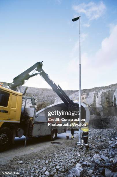 Lamp standards are fitted along the road side using a lorry mounted remote operated crane Foundations have been checked on the virtual model to...