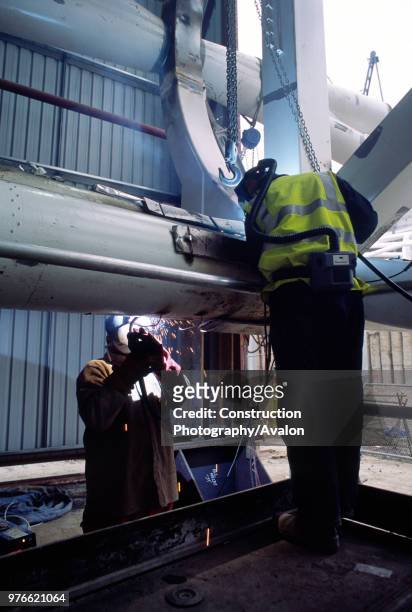 Wembley stadium-London: Welding on the interlacing steel tubes of the signature arch, constructed on the ground by Cleveland Bridge After lifting the...
