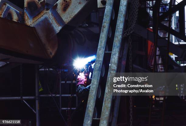 Wembley stadium-London: Welding on the interlacing steel tubes of the signature arch, constructed on the ground by Cleveland Bridge After lifting the...