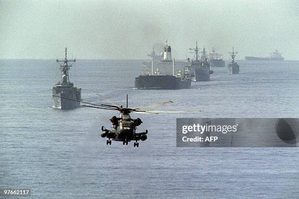 Navy minesweeping helicopter leads the way for the 12th US reflagged Kuwaiti tanker convoy 22 October 1987. Two tankers, Gass Prince and Ocean City,...