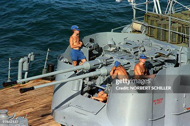 Sailors aboard a Russian warship take time out to enjoy the sun while their ship sits idle in international waters 24 October 1987. Suspected Iranian...