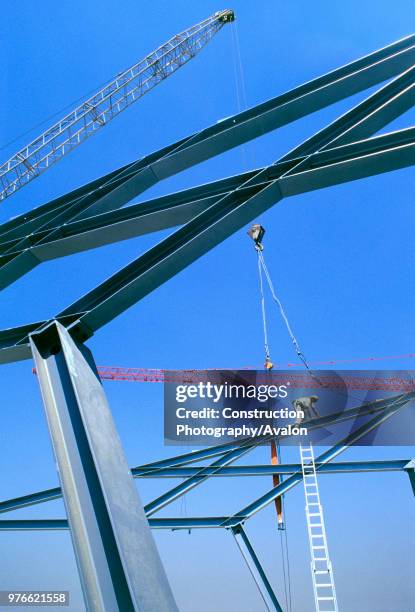 Construction workers assembling steel modular structure Steel worker on the graphic shapes of the steel roof frame for the tennis courts at the...