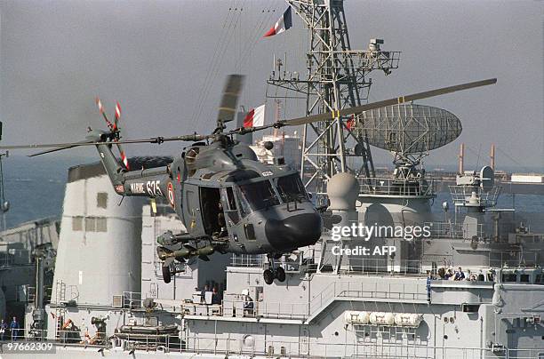 An armed French Navy helicopter aboard the French warship Dupleix takes off as the warship escorts 3 French flagged tankers out of the Gulf December...