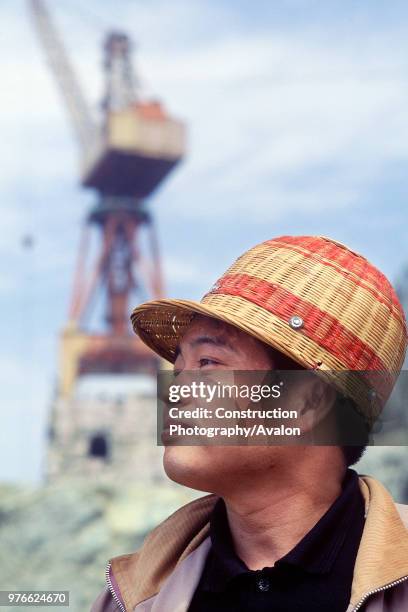 Chinese site worker wearing bamboo hard hat Three Gorges Dam, Yangtse River Sandouping, Yichang, Hubei Province, China.