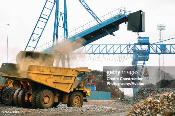 Dumper truck caterpillar cat 7710 at a metal recycling facility on the dockside at a port in Newport, South Wales, UK.