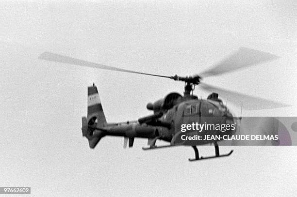 An Iraqi helicopter flies over the front line during the battle for the city of al-Howeizah, north of Basra on March 18, 1985. The Iraq-Iran war...