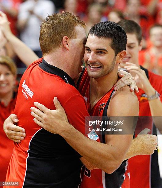 Kevin Lisch is congratulated by Rob Beveridge after being awarded MVP of the Grand Final during game three of the NBL Grand Final Series between the...