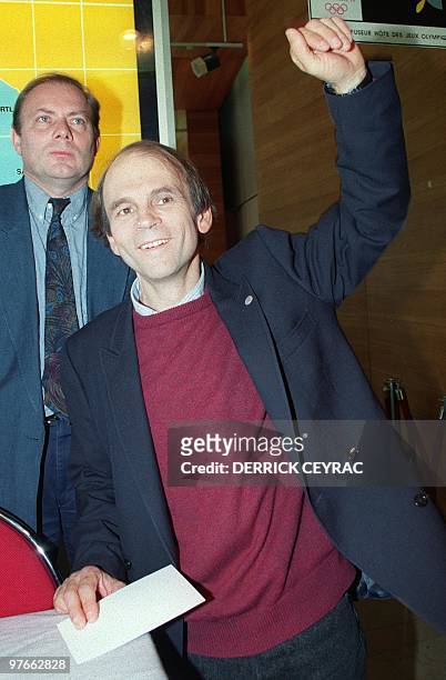 Frenchman Gerard d'Aboville raises his fist up in victory 27 November 1991 after his first press conference in Paris after successfully completing...