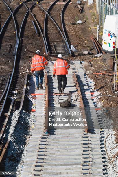 Balfour Beatty contractors walk along newly laid concrete sleepers at Redbridge station, Southampton, Hampshire on 5 March 2006 The old track and...