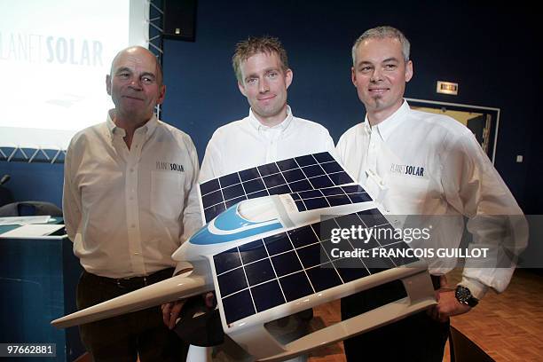 French crew members Gerard D'Aboville, Raphael Domjan and technologist Richard Mesple pose in front their boat model during a press conference to...