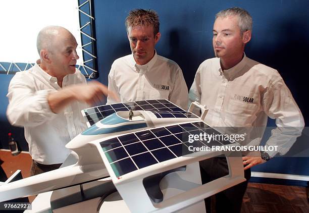 French crew members Gerard D'Aboville, Raphael Domjan and technologist Richard Mesple pose in front their boat model during a press conference to...