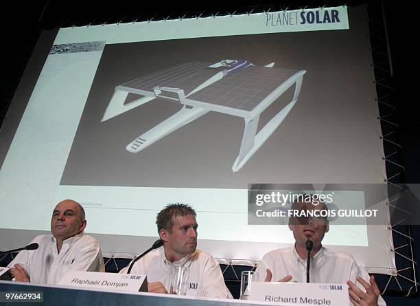 French crew members Gerard D'Aboville, Raphael Domjan and technologist Richard Mesple speak in front their boat model during a press conference to...
