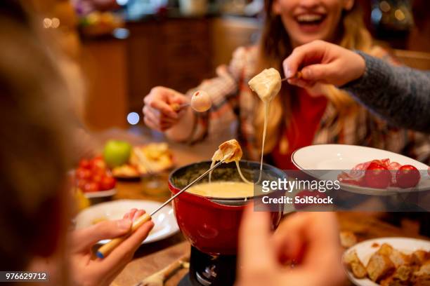 coworkers eating fondue - table dinner winter imagens e fotografias de stock