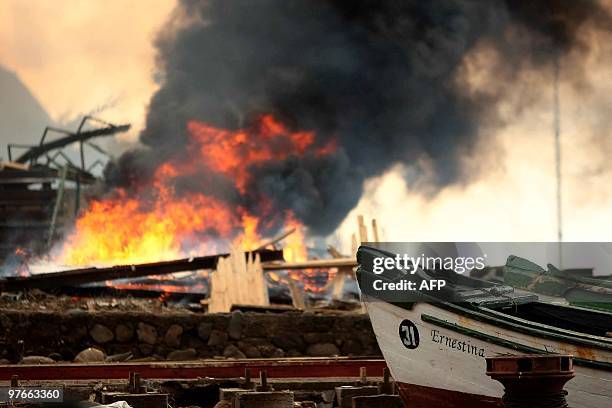 Debris is burnt on March 4, 2010 in a town of the Juan Fernandez island group, days after constructions along the coast were wiped out by last...