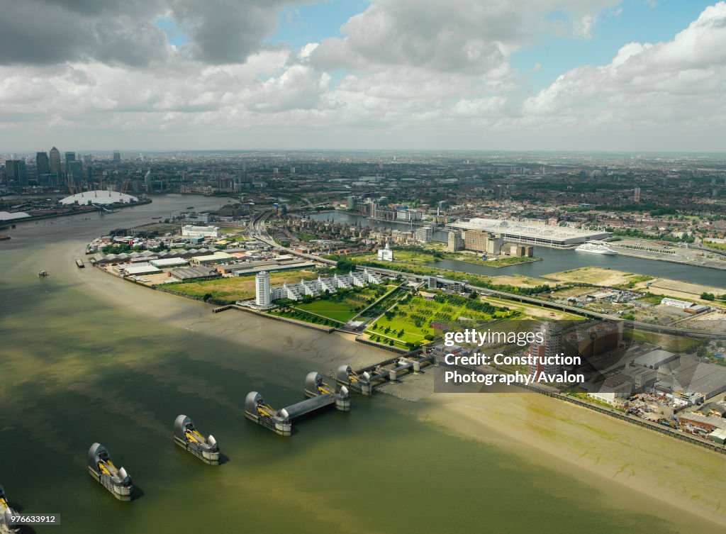 Aerial view of the Thames Barrier, ExCel Exhibition Centre on Royal Victoria Dock, Barrier Point, a landmark prestige housing development by Barratt, Tradewinds Barratt development, The Millennium Dome and Canary Wharf in the background London Docklands,