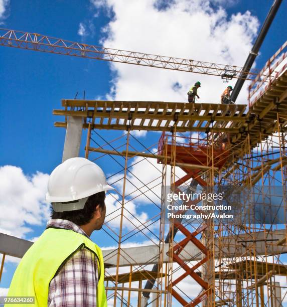 Engineering personnel supervising work on a new shopping center, Portugal.