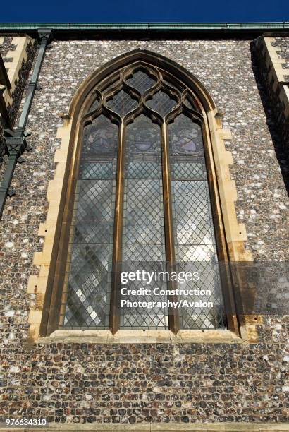 Stained glass window on the perpendicular gothic style medieval Church of St Andrew, Norwich, UK.