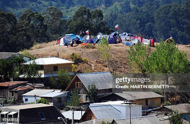 People camp in the high parts of Constitucion, some 300 km south of Santiago, on March 4, 2010. The official death toll from Saturday's 8.8-magnitude...