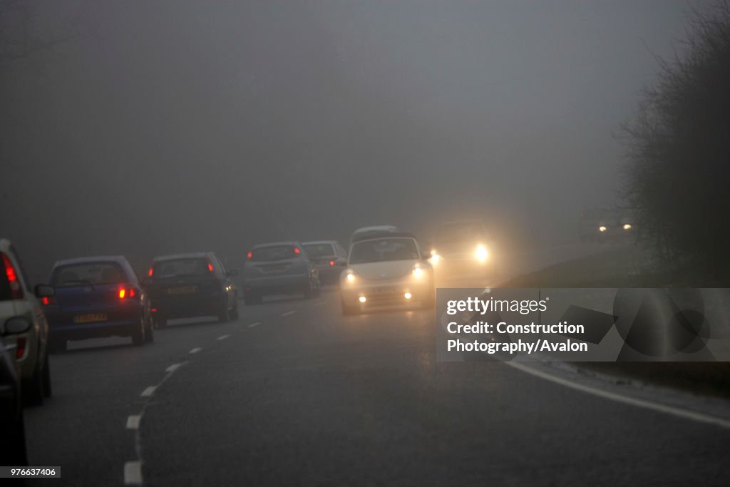 Traffic on road with bad visibility, rain and fog, United Kingdom