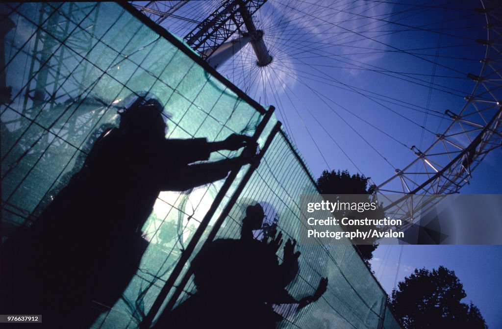 Fencing the perimeter during the construction of the Millenium Wheel, London