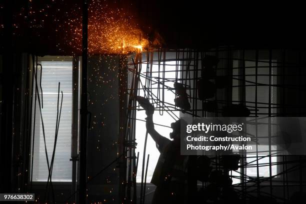 Cutting through reinforced steel bar during demolition of former stock exchange, London, UK.