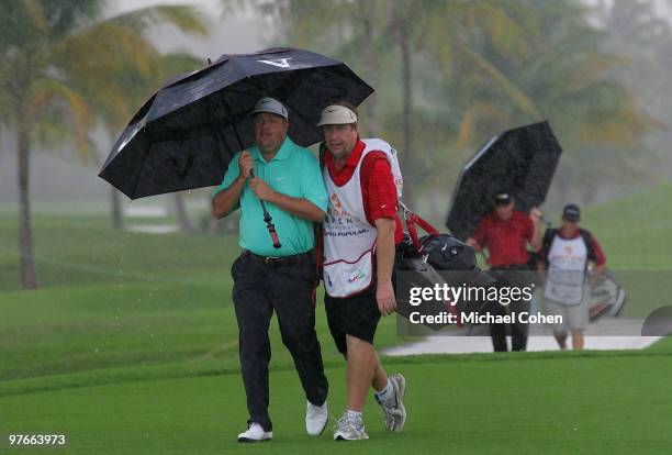 Carl Pettersson of Sweden leaves the course as play is suspended during the continuation of the first round of the Puerto Rico Open presented by...