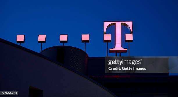 The logo of the German telecoms provider Deutsche Telekom is pictured at twilight at the company's headquarters on March 09, 2010 in Bonn, Germany.
