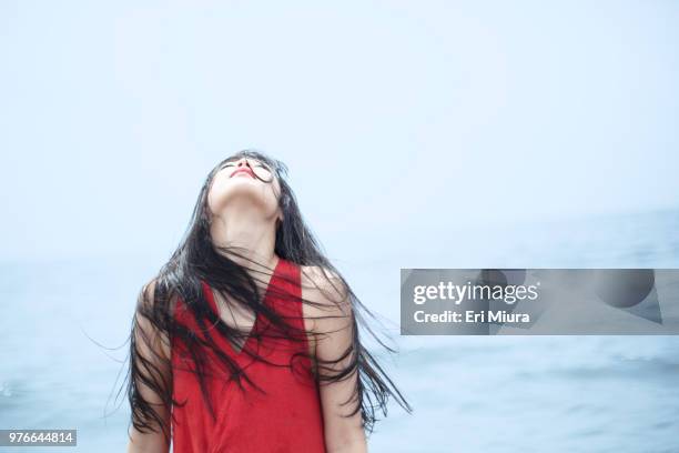 a woman dancing in the sea - schmerzfrei stock-fotos und bilder