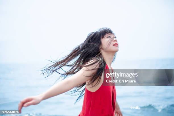 a woman dancing in the sea - desiderio foto e immagini stock