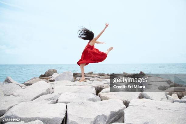 a woman dancing in the sea - dance challenge stock pictures, royalty-free photos & images