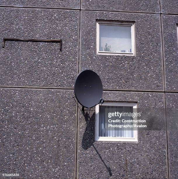 Satellite dish on the facade of a 1970's council tower block, Islington, London.