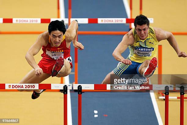 Xiang Liu of China and Philip Nossmy of Sweden compete in the mens 60m hurdle heats during Day 1 of the IAAF World Indoor Championships at the Aspire...