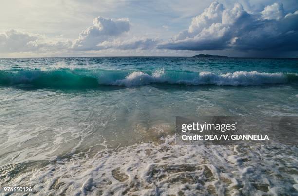 Sea and cloudy sky, with Aride island in the background, Praslin island, Seychelles.