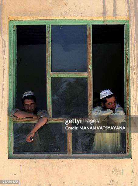 Afghan election workers wait for voters at a polling centre at Baraki Barak district in Logar Province on August 20, 2009. Afghans voted to elect a...