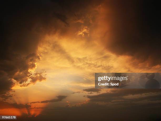 stormy sunset with clouds and sun - storm cloud sun stock pictures, royalty-free photos & images