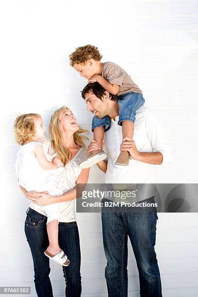 family with two children - studio relations stock pictures, royalty-free photos & images