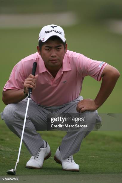 Yuta Ikeda of Japan lines up a putt on the first hole during round two of the 2010 WGC-CA Championship at the TPC Blue Monster at Doral on March 12,...