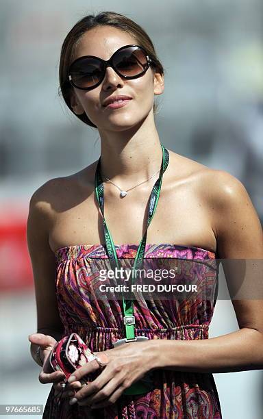 McLaren Mercedes' British driver Jenson Button's girlfriend Jessica Michibata walks in the paddock of the Bahrain international circuit on March 12,...