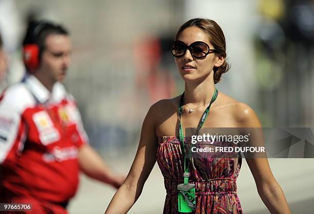 McLaren Mercedes' British driver Jenson Button's girlfriend Jessica Michibata walks in the paddock of the Bahrain international circuit on March 12,...