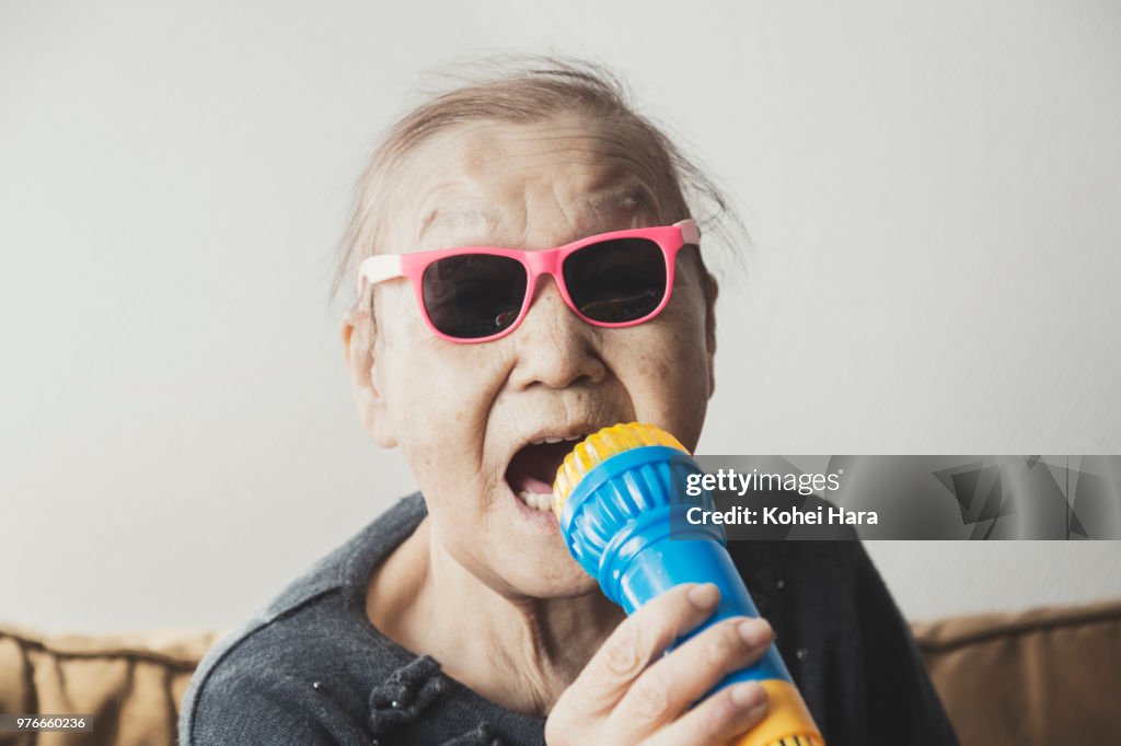 Homemade senior rock singer wearing toy sunglasses