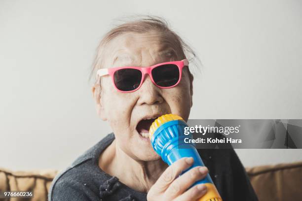 homemade senior rock singer wearing toy sunglasses - asian crazy stock pictures, royalty-free photos & images