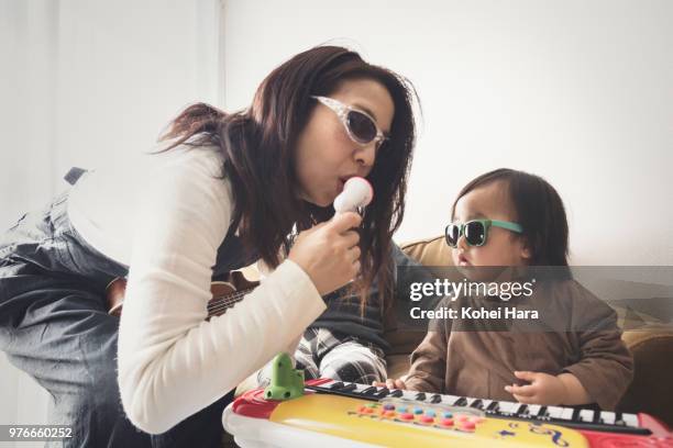 homemade rock band wearing toy sunglasses - quirky family stock-fotos und bilder