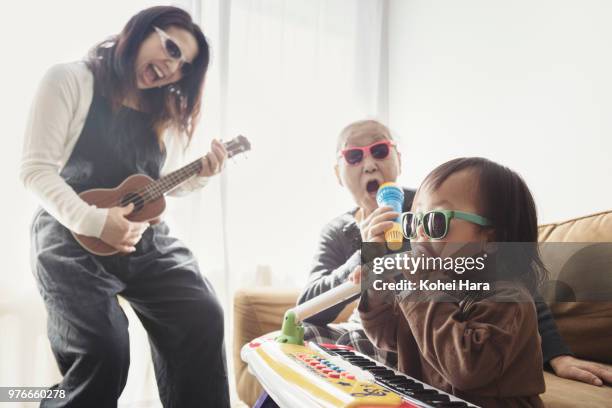 homemade rock band wearing toy sunglasses - quirky family stockfoto's en -beelden