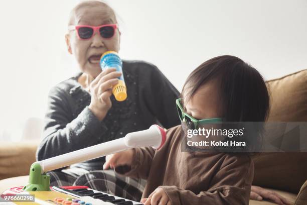 homemade rock band wearing toy sunglasses - funny baby photo stock pictures, royalty-free photos & images
