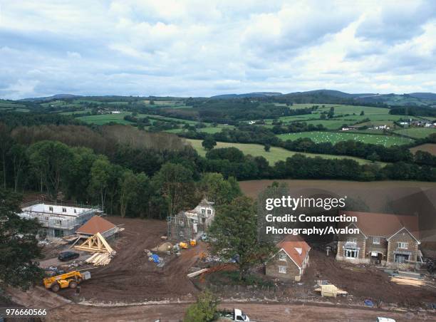 Construction of new detached houses with conversion of stable block to house nearby, Wales.