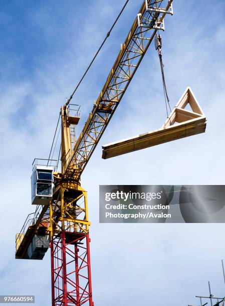 Building material delivered by a crane lift.