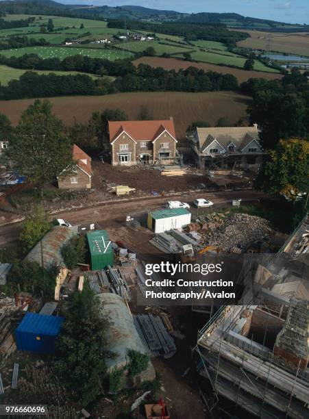 Traditional new build in background, conversion of 16th century Grade II listed country house in foreground, View from the site tower crane showing...