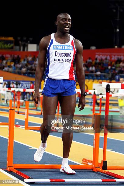 Ladji Doucoure rof France reacts after knocking down a hurdle competes in the mens 60m hurdle heats during Day 1 of the IAAF World Indoor...