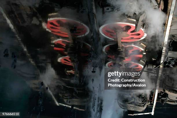 The driving wheels of a Chinese SY industrial Mikado 2-8-2 reflected in icy water at Baotou Steelworks, Inner Mongolia. March 2005.